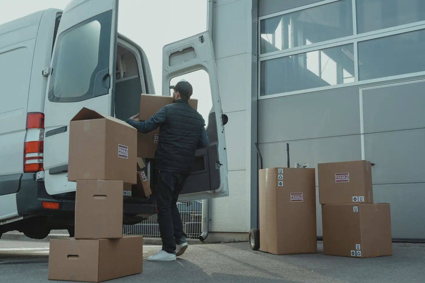 Equipment cartons being loaded into a delivery van for a field office