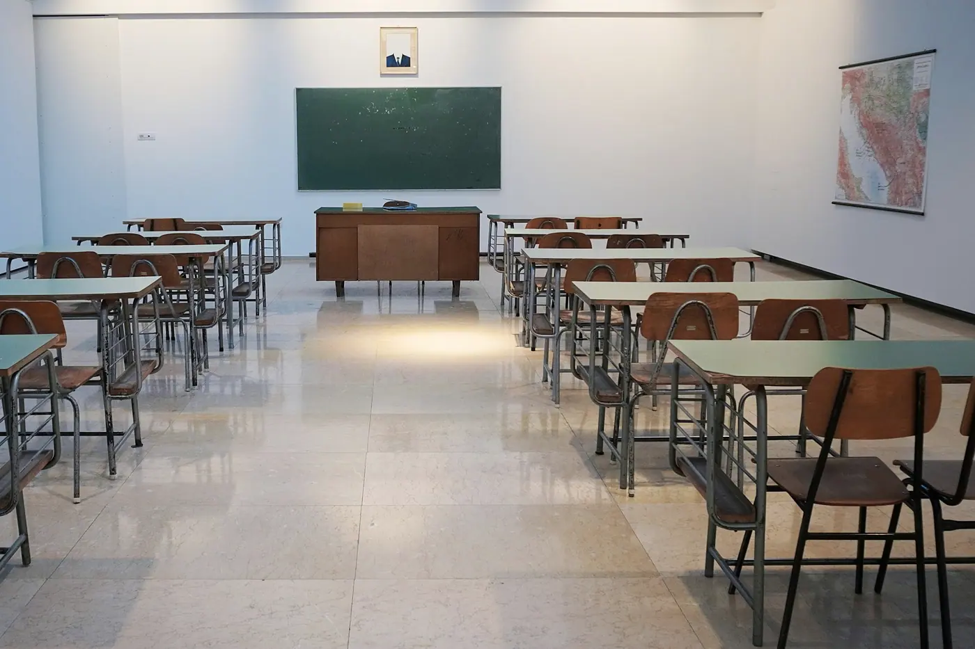 Interactive smart board display mounted in a classroom with students seated